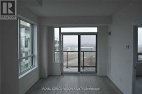 Pickering (Bay Ridges) condo for rent - A room with a view of the city through large windows.
