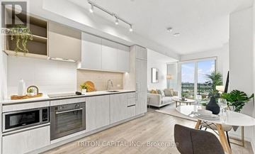 Vaughan (Vaughan Corporate Centre) condo for rent - A modern kitchen with a dining area in a real estate brokerage.