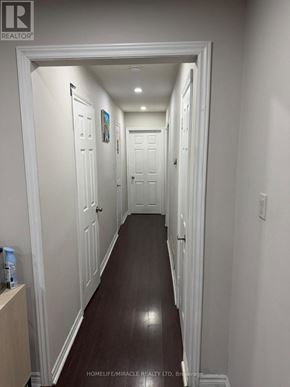 Toronto (West Humber-Clairville) apartment for rent - A hallway with white doors and dark wood floors.