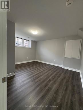 Milton (Fo Ford) apartment for rent - A room with wood flooring and a window.