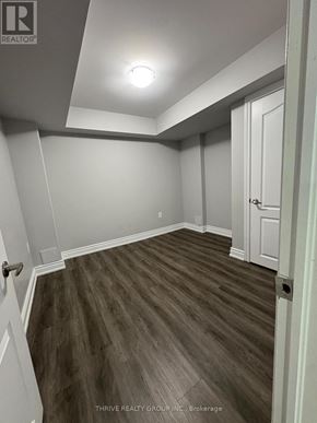 Milton (Fo Ford) apartment for rent - A room with a wooden floor and white walls.