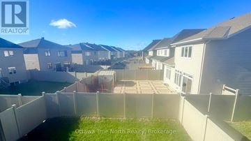 Ottawa apartment for rent - A row of houses with a fence in front of them.