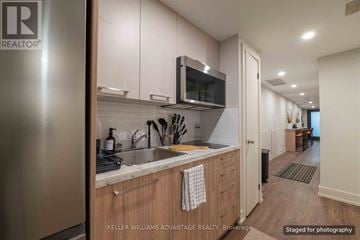 Toronto (Kensington-Chinatown) apartment for rent - A modern kitchen with wooden cabinets and stainless steel appliances.
