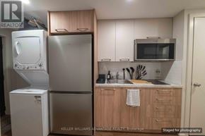 Toronto (Kensington-Chinatown) apartment for rent - A kitchen with a refrigerator, microwave, and sink.