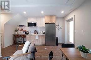 Toronto (Kensington-Chinatown) apartment for rent - A modern kitchen with a refrigerator, microwave, and oven.
