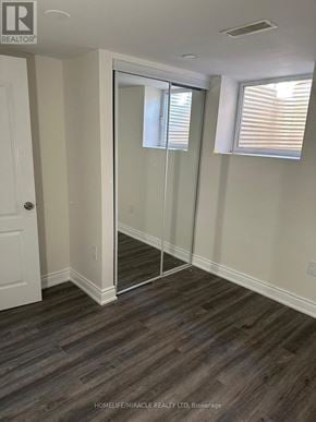 Vaughan (West Woodbridge) apartment for rent - A room with a glass door and wooden flooring.