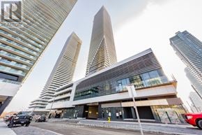 Toronto (Mimico) condo for rent - A modern building with a unique triangular design stands out among other skyscrapers.