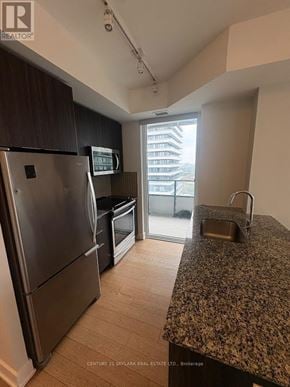 Toronto (Mimico) condo for rent - A kitchen with granite countertops and stainless steel appliances.