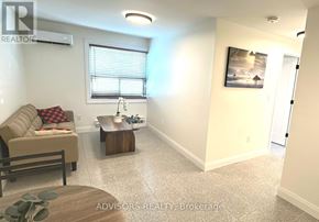 Toronto (Long Branch) apartment for rent - A living room with a couch, a coffee table, and a painting on the wall.