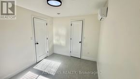Toronto (Long Branch) apartment for rent - A room with two doors and a brokerage logo.