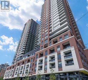 Toronto (Humber Heights) condo for rent - A tall building with a glass facade stands next to a shorter building with a brick facade.