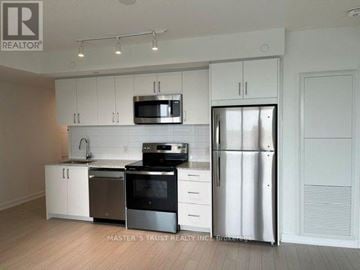 Toronto (Humber Heights) condo for rent - A kitchen with white cabinets and stainless steel appliances.