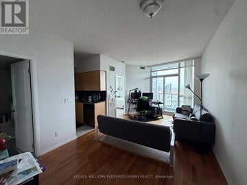 Toronto (Waterfront Communities) condo for rent - A living room with a couch and a television.