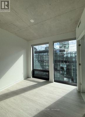 Toronto (Moss Park) condo for rent - A room with a view of a cityscape through the windows.