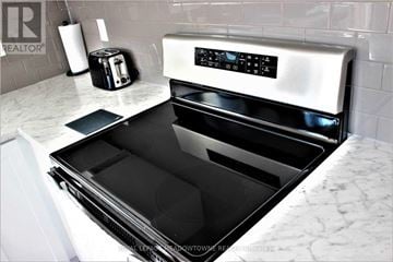 Hamilton (Hannon) townhouse for rent - A modern kitchen with a stainless steel oven and a toaster on the counter.