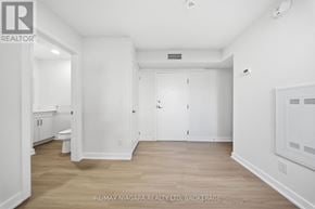 St. Catharines (Downtown) multi-family for rent - A white room with wood flooring and a doorway leading to another room.