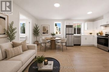 St. Catharines (Downtown) multi-family for rent - A well-lit, modern kitchen and living room with a dining table and chairs.