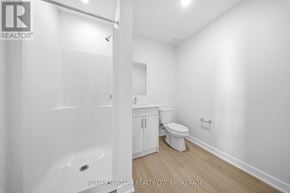 St. Catharines (Downtown) multi-family for rent - A white bathroom with a toilet and sink.