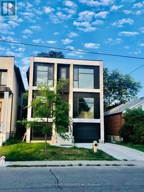 Toronto (Clairlea-Birchmount) duplex for rent - A modern two-story house with a garage is situated on a quiet street.