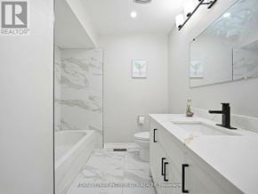 Brampton (Madoc) apartment for rent - A white bathroom with a marble patterned tub and sink.