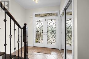 Milton (Be Beaty) apartment for rent - A hallway with a staircase and a glass door with a decorative design.