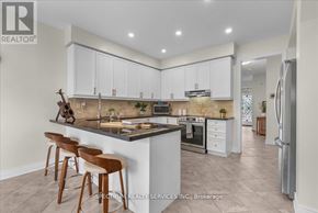 Milton (Be Beaty) apartment for rent - A modern kitchen with a bar area and wooden stools.