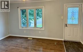 Windsor apartment for rent - A room with a wooden floor, a white door, and a window with a view of the outside.