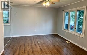 Windsor apartment for rent - A room with wooden floors and a ceiling fan.