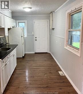 Windsor apartment for rent - A kitchen with white cabinets and a black counter top.