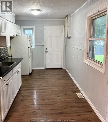 Windsor apartment for rent - A kitchen with white cabinets and a black counter top.