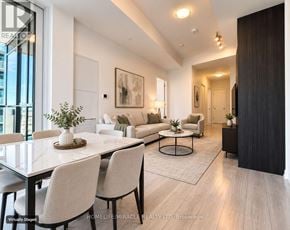 Toronto (Waterfront Communities) condo for rent - A modern living room with a dining table and chairs.