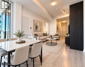 Toronto (Waterfront Communities) condo for rent - A modern living room with a dining table and chairs.