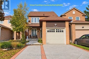 Mississauga (Meadowvale) apartment for rent - A house with a brown roof and a white garage door is for sale.