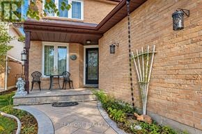 Mississauga (Meadowvale) apartment for rent - A brick house with a black door and a small porch.