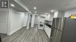 Mississauga (Meadowvale) apartment for rent - A kitchen with a refrigerator, microwave, and oven.