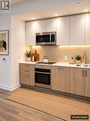 Toronto (High Park-Swansea) condo for rent - A modern kitchen with a stainless steel oven and microwave.