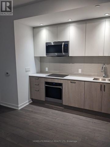Toronto (High Park-Swansea) condo for rent - A modern kitchen with a stainless steel oven and microwave.