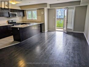 Oakville (Wm Westmount) townhouse for rent - A kitchen with black cabinets and a black counter top.
