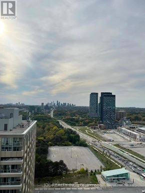 Toronto (Flemingdon Park) condo for rent - A cityscape with tall buildings and a highway in the foreground.
