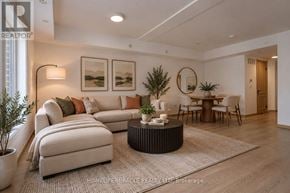 Toronto (Tam O'shanter-Sullivan) condo for rent - A modern living room with a large sofa, a coffee table, and a dining table set up.