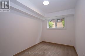 Toronto (Tam O'shanter-Sullivan) condo for rent - A room with a window and wooden flooring.