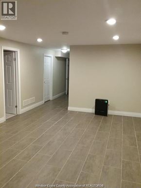 Windsor apartment for rent - A room with a tiled floor and a black box on the floor.