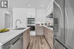 Gibsons apartment for rent - A modern kitchen with wooden cabinets and stainless steel appliances.