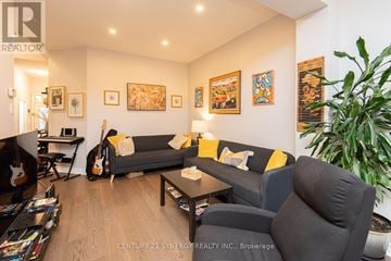 Ottawa townhouse for rent - A living room with a grey couch and a guitar.