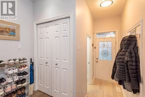 Ottawa townhouse for rent - A hallway with a white door and a coat hanging on the wall.