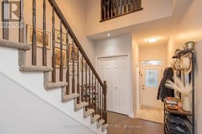 Ottawa townhouse for rent - A staircase with a white wall and a white door.