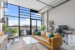 Toronto (Niagara) condo for rent - A living room with a couch, a desk, and a chair.