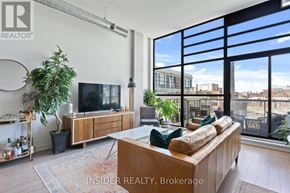 Toronto (Niagara) condo for rent - A living room with a couch, television, and large windows.