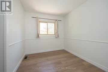 Oakville (Fd Ford) apartment for rent - A room with a window and wooden flooring.