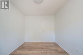 Oakville (Fd Ford) apartment for rent - A room with a wooden floor and a white door.
